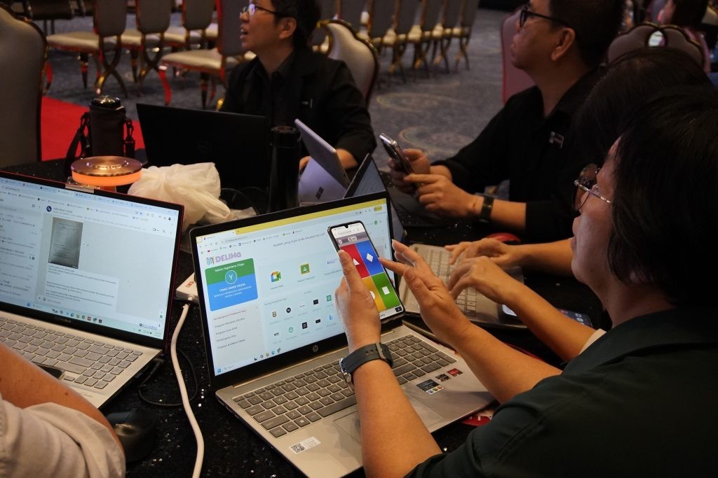 A teacher using a specialized AI tool during the hands-on corporate AI training style workshop.