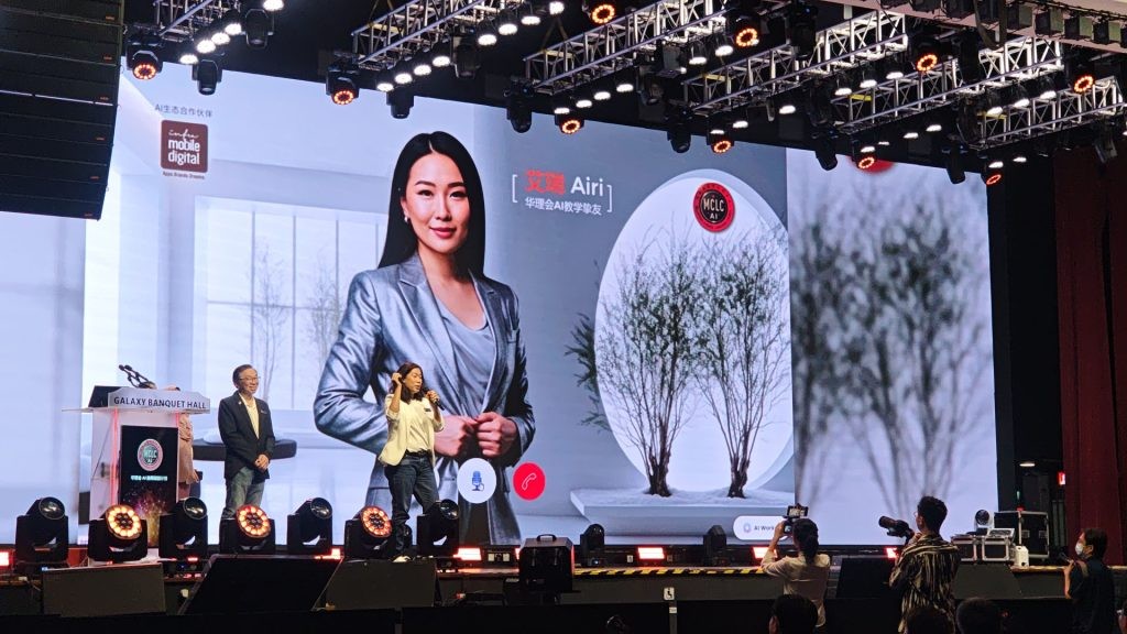 Tina Leon and Datuk Eddie Heng on stage during a live demonstration with the interactive AI Avatar 'Airi' displayed on a large screen at the MCLC AI-Empowered Education workshop.